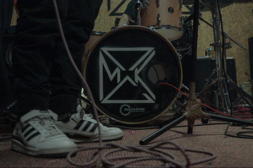 Bass drum head with the PSMK logo during a rehearsal